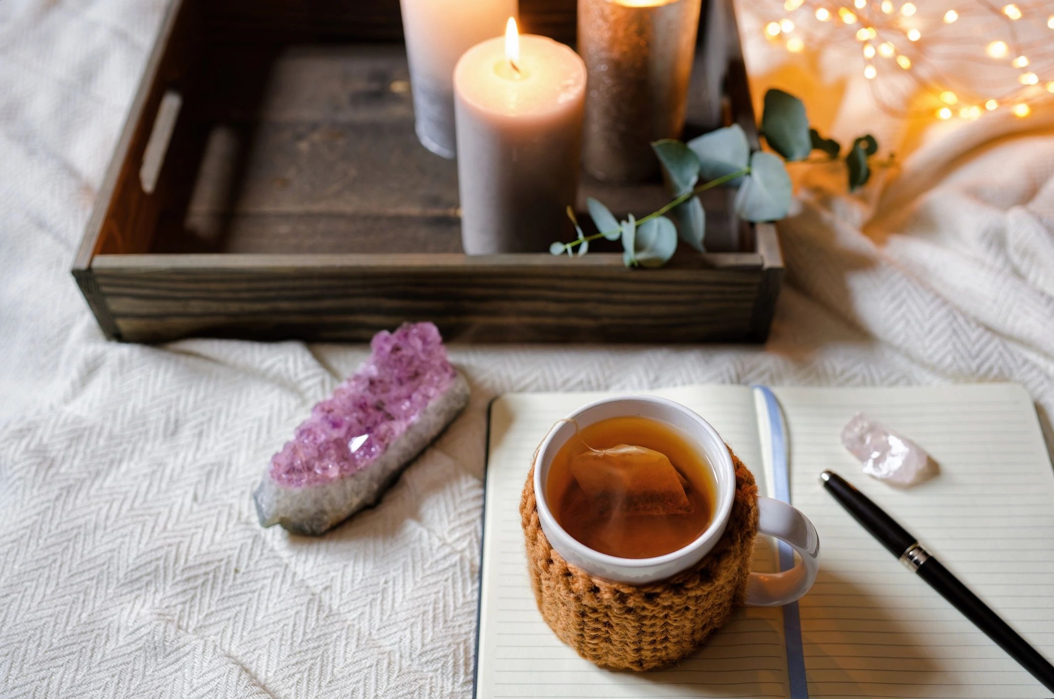 Journal and tea arranged for a calming wellness routine